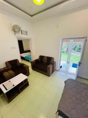 a living room with a bed and a couch at 7FORT HOMESTAY Athirappilly in Athirappilly