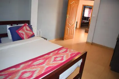a bedroom with a bed with a colorful blanket on it at Mass villa in Ooty