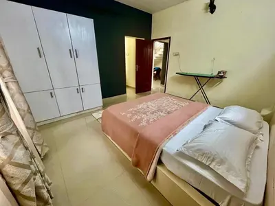 a bedroom with a bed and a table in it at Krishnakripa - Luxury Private Villa Near Guruvayoor Temple in Guruvāyūr