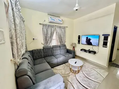 a living room with a couch and a table at Krishnakripa - Luxury Private Villa Near Guruvayoor Temple in Guruvāyūr