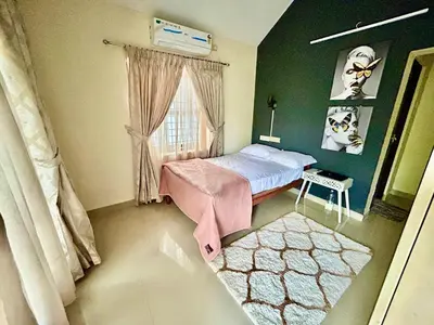 a bedroom with a small bed and a window at Krishnakripa - Luxury Private Villa Near Guruvayoor Temple in Guruvāyūr