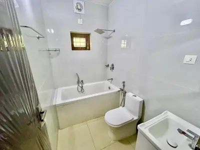 a bathroom with a toilet and a tub and a sink at Krishnakripa - Luxury Private Villa Near Guruvayoor Temple in Guruvāyūr