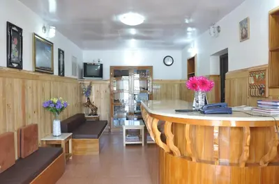 a lobby with a counter with flowers on it at Trilan Cottages - Donnington Road in Kotagiri