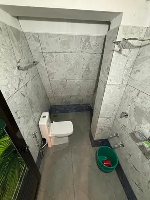 a small bathroom with a toilet and a shower at Wild Castle Wayanad in Pulpally