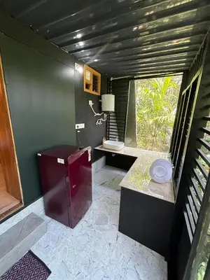 a bathroom with a large window and a sink at Wild Castle Wayanad in Pulpally