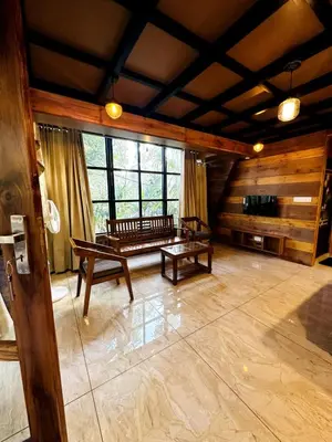 a large room with a bench and a large window at Wild Castle Wayanad in Pulpally