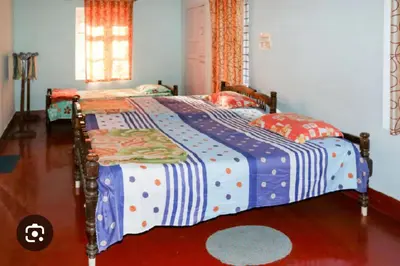 a bedroom with two twin beds and a window at Coorg Naladi holidays in Kakkabe