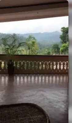 a balcony with a view of a mountain at Coorg Naladi holidays in Kakkabe