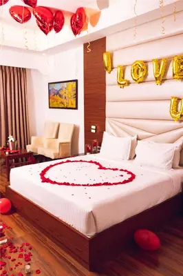 a bedroom with a bed with red and gold decorations at Avana Resort in Mettuppālaiyam