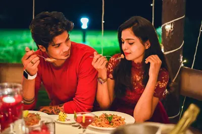 a man and a woman sitting at a table eating food at Avana Resort in Mettuppālaiyam