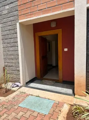 an entrance to a building with a brick wall at Aalayam, Villament & private pool in Mysore