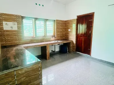a bathroom with a sink and a desk in it at Misty Homes Stay in Napoklu