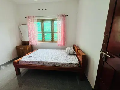 a small bedroom with a bed and a window at Misty Homes Stay in Napoklu