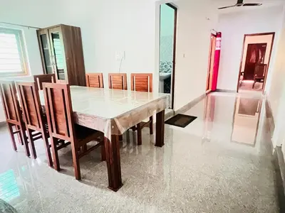 a dining room with a table and chairs at Misty Homes Stay in Napoklu