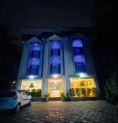 a blue lit building with a car parked in front at Hydel Palace Athirappilly by Bestinn Leisure in Athirappilly