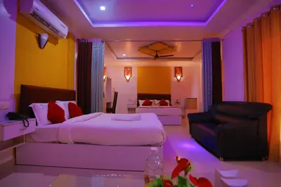 a hotel room with a bed and a couch at Hydel Palace Athirappilly by Bestinn Leisure in Athirappilly