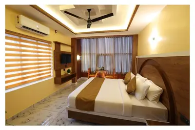 a bedroom with a large bed in a room at Hydel Palace Athirappilly by Bestinn Leisure in Athirappilly