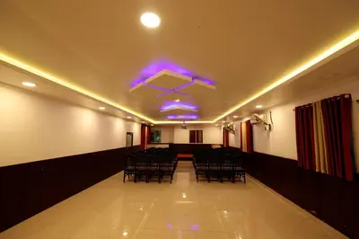 a room with chairs and purple lights on the ceiling at Hydel Palace Athirappilly by Bestinn Leisure in Athirappilly
