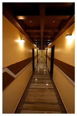 a long hallway with lights on the wall at Hydel Palace Athirappilly by Bestinn Leisure in Athirappilly