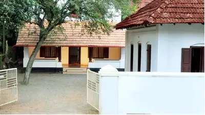 a white fence in front of a house at Wariyam Heritage in Trichūr