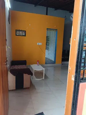 a room with a couch and a table and a yellow wall at Lilly Farm in Halgūr