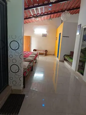 a room with a row of beds in a building at Lilly Farm in Halgūr