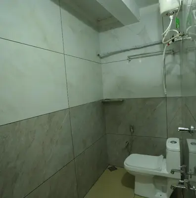a bathroom with a toilet and a shower at Port View Residency PVR in Nedumbassery