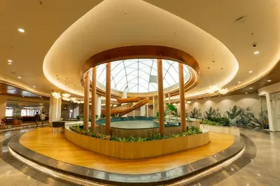 a lobby of a hotel with a large building at 0484 Aero Lounge-Terminal 2 Cochin Airport Hotel in Nedumbassery