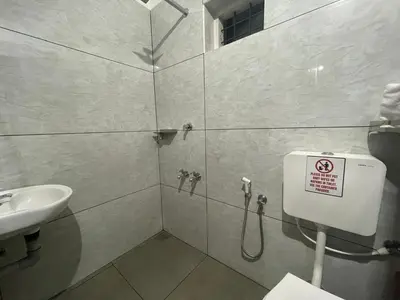a bathroom with a shower with a sink and a toilet at D Villas in Kunnamangalam