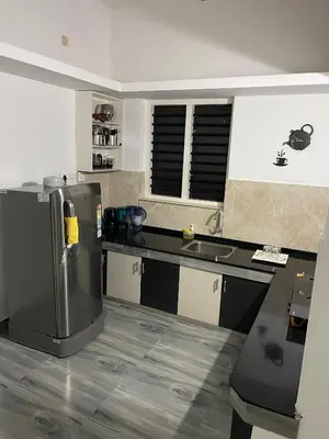 a kitchen with a refrigerator and a sink at D Villas in Kunnamangalam