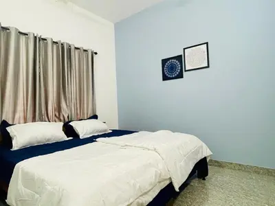 a bedroom with a bed and a window at D Villas in Kunnamangalam