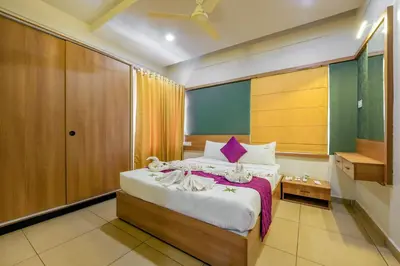 a bedroom with a large bed in a room at Focuz Habitat Hotel And Ayurveda in Malappuram