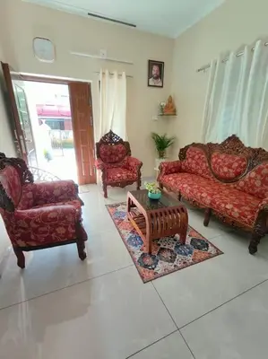 a living room with two couches and a coffee table at Krishnarpanam 2BHK villa in Guruvayoor- only for families in Guruvāyūr