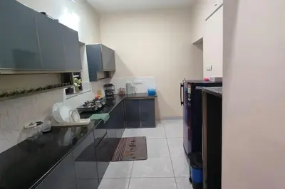 a kitchen with black and white counter tops in a room at Krishnarpanam 2BHK villa in Guruvayoor- only for families in Guruvāyūr