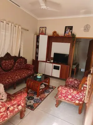 a living room with couches and a tv at Krishnarpanam 2BHK villa in Guruvayoor- only for families in Guruvāyūr