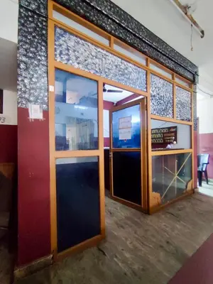 a room with two glass doors in a building at Omega Tourist Home in Trichūr