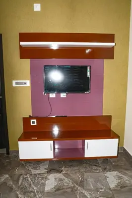 a flat screen tv sitting on top of a shelf at Ecostay inn in Sultan Bathery
