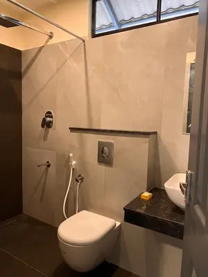 a bathroom with a toilet and a sink at Hill View Heights Wayanad in Meppādi