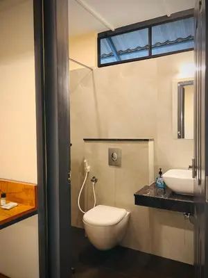 a bathroom with a toilet and a sink at Hill View Heights Wayanad in Meppādi