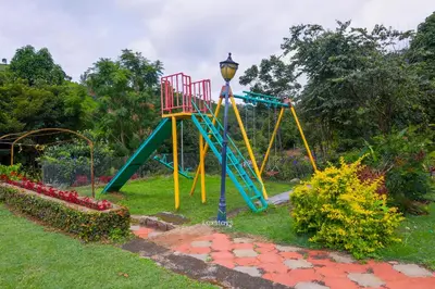 a playground with a colorful slide in a park at 42 Green Pastures By Lexstays -Tea Estate Experience in Coonoor