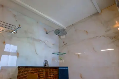 a bathroom with a marble wall and a sink at 42 Green Pastures By Lexstays -Tea Estate Experience in Coonoor
