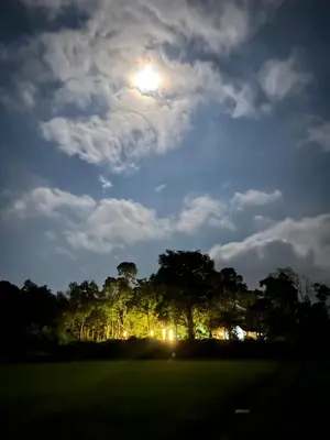 a full moon over a golf course at night at TauSco Homestay & Campsite - Coorg in Madikeri