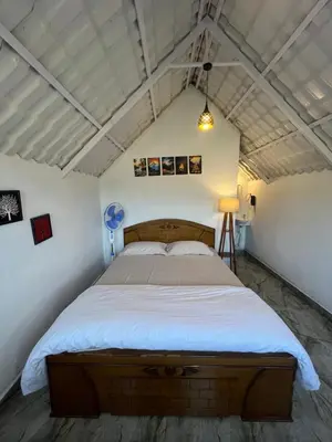 a bedroom with a large bed in a room at TauSco Homestay & Campsite - Coorg in Madikeri
