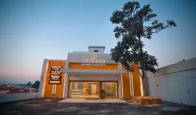 a store front of a building with a tree in front at hotel emperor in Sultan Bathery