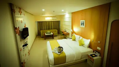 a hotel room with a large bed and a couch at hotel emperor in Sultan Bathery
