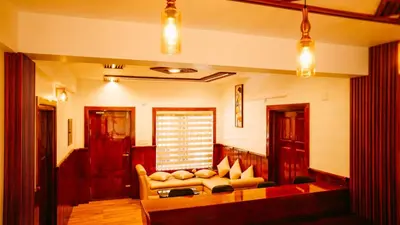 a living room with a couch and a table at Kanavu Valley View in Ooty