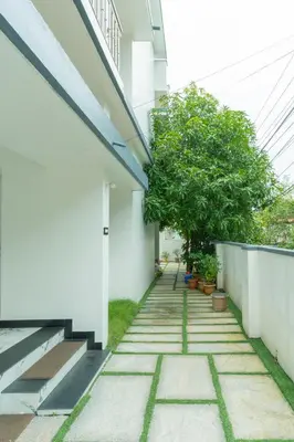 an internal courtyard of a house with trees at Be My Guest in Kozhikode