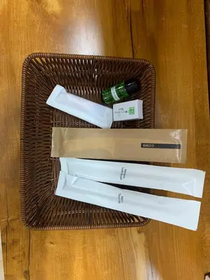 a basket with three knives and a bottle on a table at Love Green Resorts in Palladam