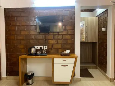 a kitchen with a counter and a brick wall at Love Green Resorts in Palladam