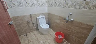 a bathroom with a white toilet in a stall at SHIs Aathira 2bhk Heart of Coimbatore in Coimbatore